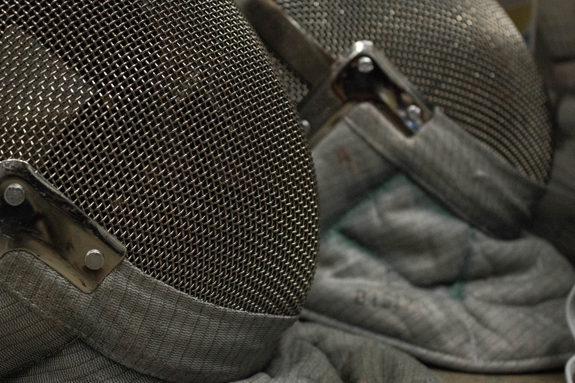 close up of two fencing masks
